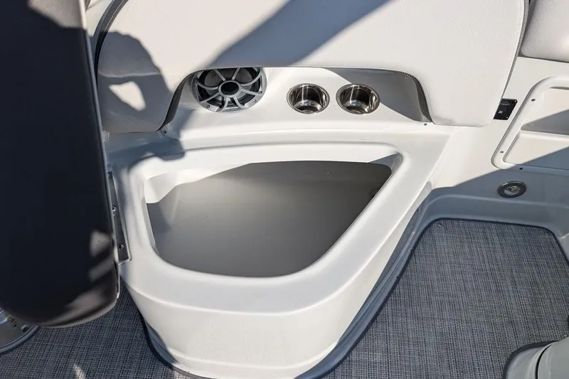 Slide: The Image of 2024 Crownline Eclipse E240 XS boat interior with speaker and cup holders. - 28