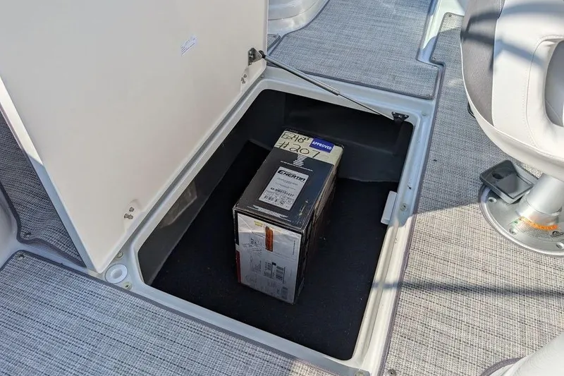 Slide: The Image of Storage compartment in 2024 Crownline Eclipse E240 XS boat with a box inside. - 29
