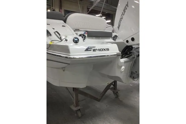 Slide: The Image of 2024 Crownline Eclipse E240 XS boat rear view in a showroom setting. - 3