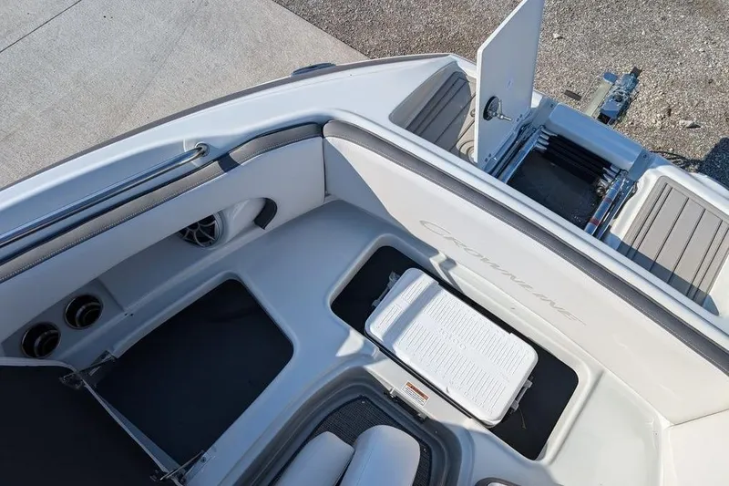 Slide: The Image of 2024 Crownline Eclipse E240 XS boat interior with storage compartments and seating. - 30
