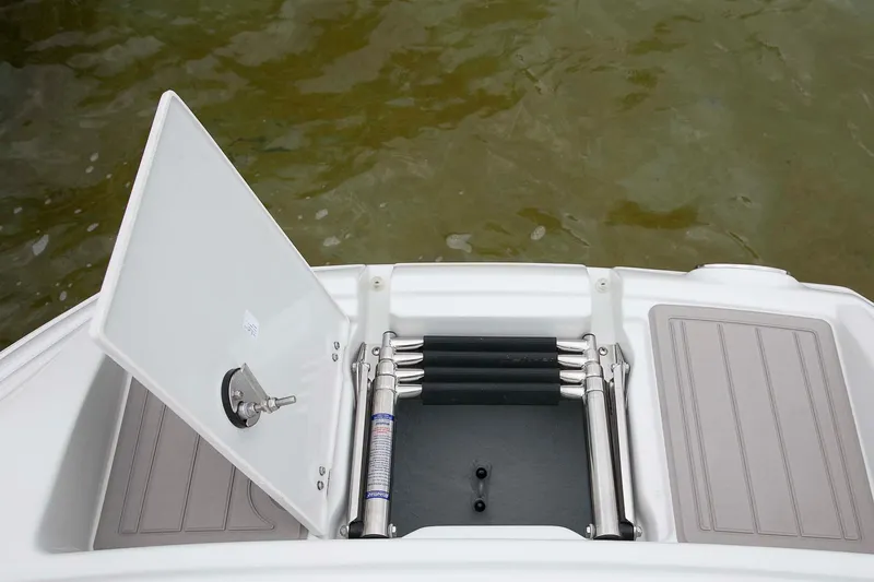 Slide: The Image of 2024 Crownline Eclipse E240 XS boat with open swim ladder compartment. - 6