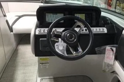 Slide: The Image of 2024 Crownline Eclipse E240 XS boat dashboard with steering wheel and control panel. - 8