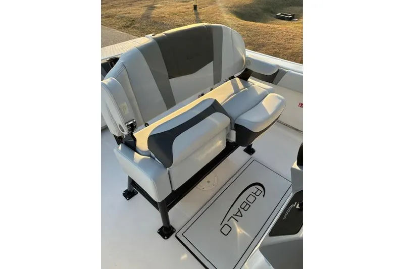 Slide: The Image of 2026 Robalo R230 Center Console boat seating with gray and black upholstery. - 12