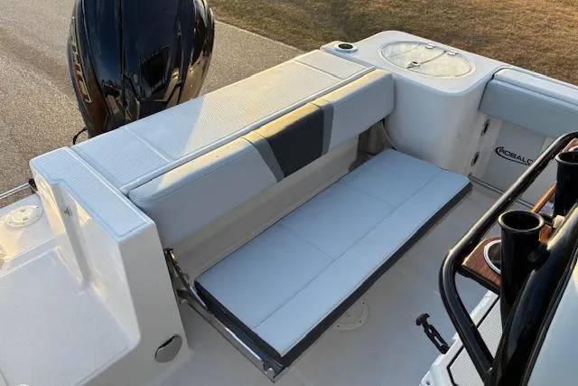 Slide: The Image of 2026 Robalo R230 Center Console boat interior with cushioned seating and storage. - 19