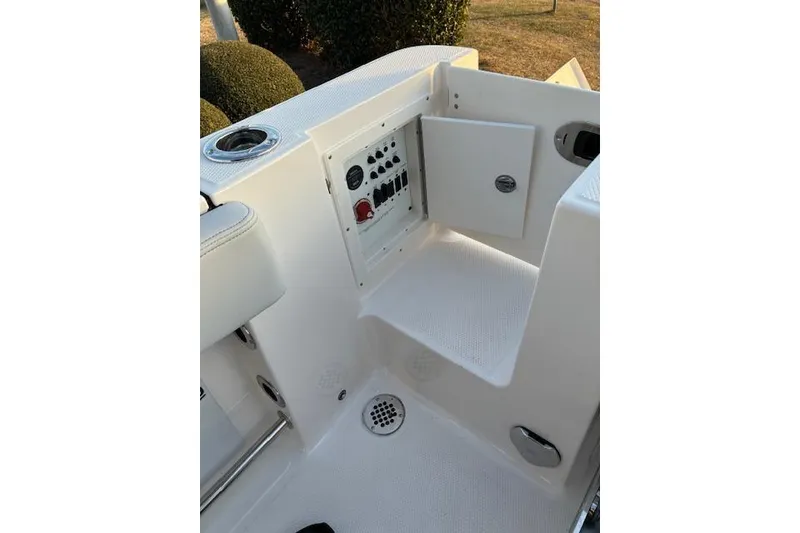Slide: The Image of 2026 Robalo R230 Center Console boat interior with control panel and seating area. - 21