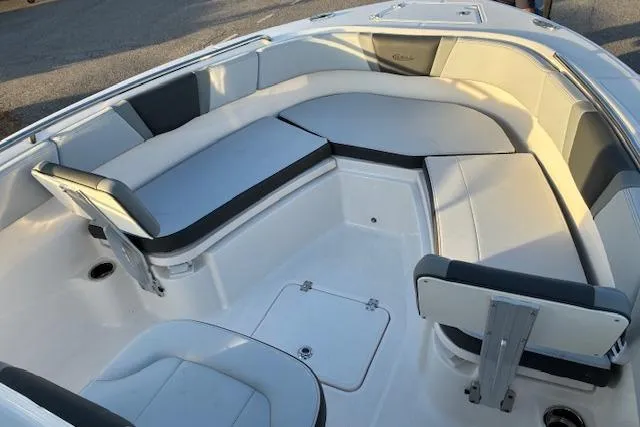 Slide: The Image of 2026 Robalo R230 Center Console boat interior with cushioned seating and storage compartments. - 9