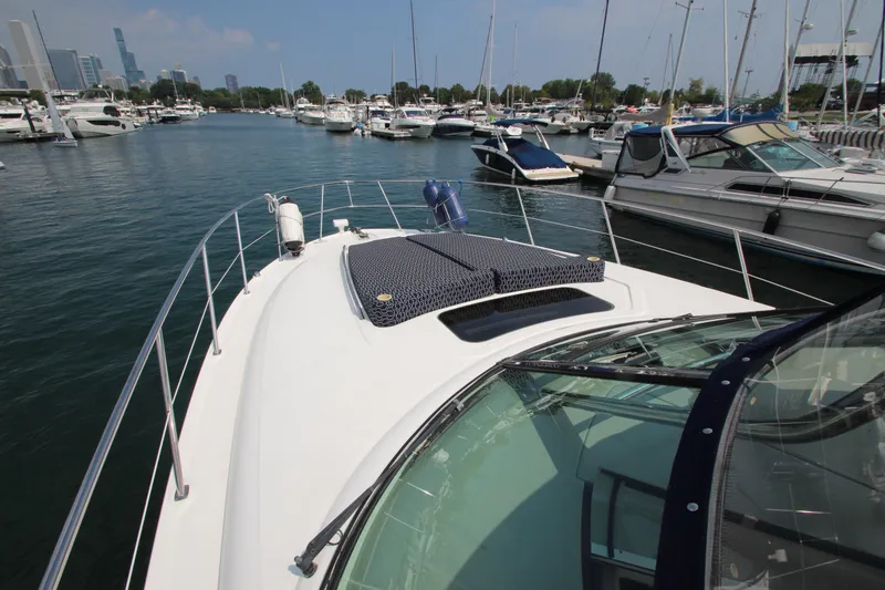 Slide: The Image of 2004 Sea Ray 40 Sundancer yacht docked in a marina with city skyline. - 14