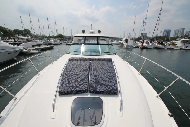 Slide: The Image of 2004 Sea Ray 40 Sundancer yacht docked in a marina with city skyline. - 17