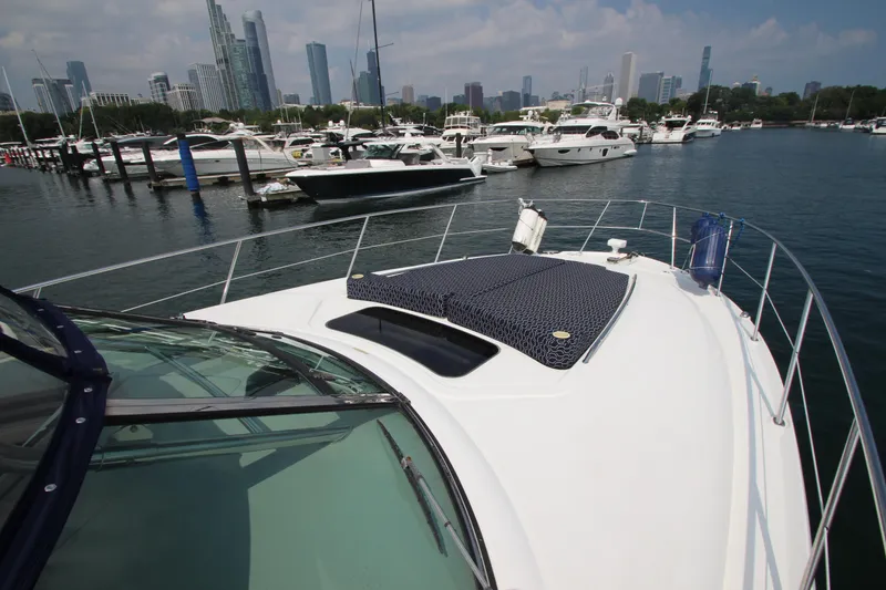 Slide: The Image of 2004 Sea Ray 40 Sundancer yacht docked in marina with city skyline in background. - 20
