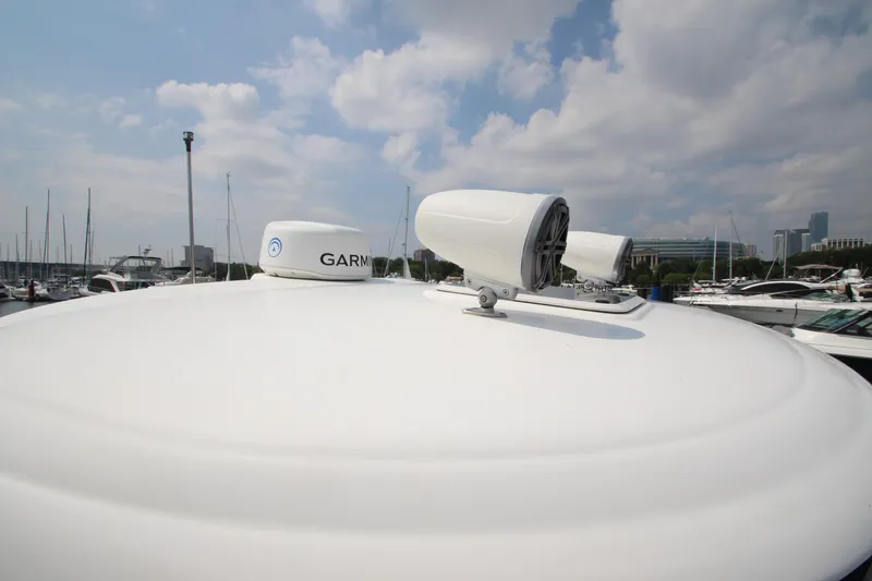 Slide: The Image of Radar equipment on a 2004 Sea Ray 40 Sundancer yacht under a cloudy sky. - 21
