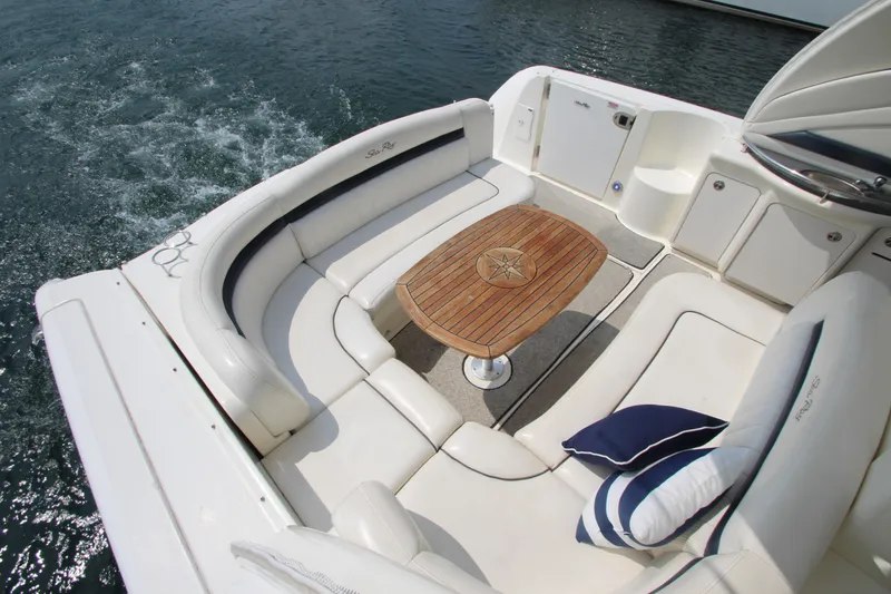 Slide: The Image of Luxurious 2004 Sea Ray 40 Sundancer yacht with elegant seating and wooden table on deck. - 23