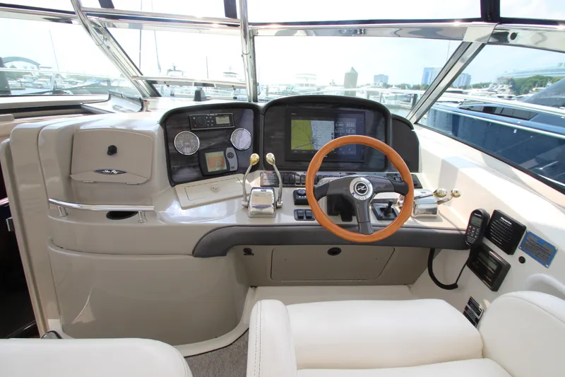 Slide: The Image of Helm of 2004 Sea Ray 40 Sundancer with modern navigation equipment and wooden steering wheel. - 24
