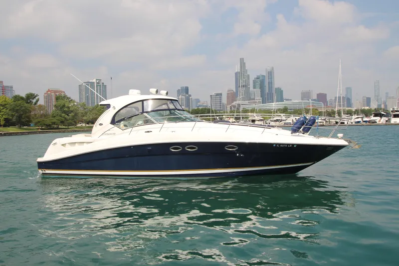 Slide: The Image of 2004 Sea Ray 40 Sundancer yacht on water with city skyline background. - 3