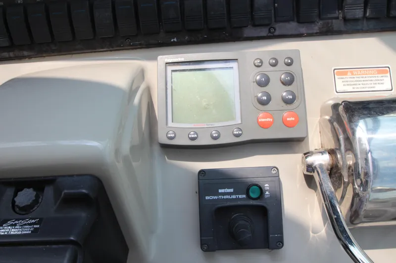 Slide: The Image of Control panel of a 2004 Sea Ray 40 Sundancer boat with navigation and bow thruster controls. - 31
