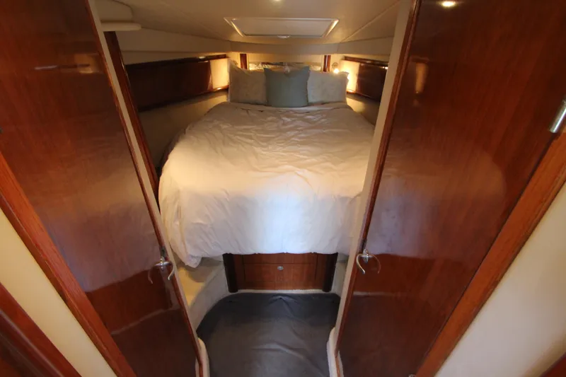 Slide: The Image of Cozy bedroom interior of 2004 Sea Ray 40 Sundancer yacht with wooden accents. - 37
