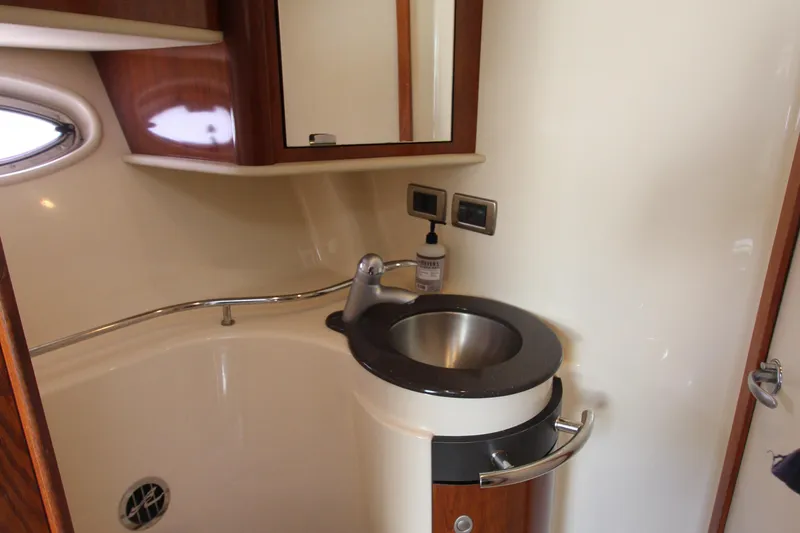 Slide: The Image of 2004 Sea Ray 40 Sundancer bathroom with modern sink and wooden cabinetry. - 40