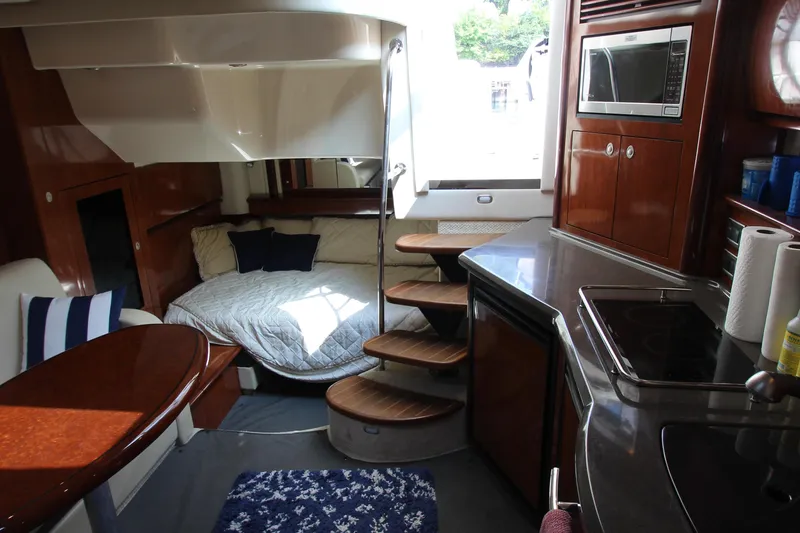 Slide: The Image of Luxurious interior of 2004 Sea Ray 40 Sundancer yacht with cozy bed and modern kitchen. - 42