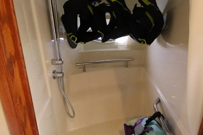 Slide: The Image of Shower area in 2004 Sea Ray 40 Sundancer with hanging life jackets. - 43