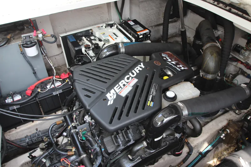 Slide: The Image of Engine compartment of a 2004 Sea Ray 40 Sundancer with Mercury engine components. - 54