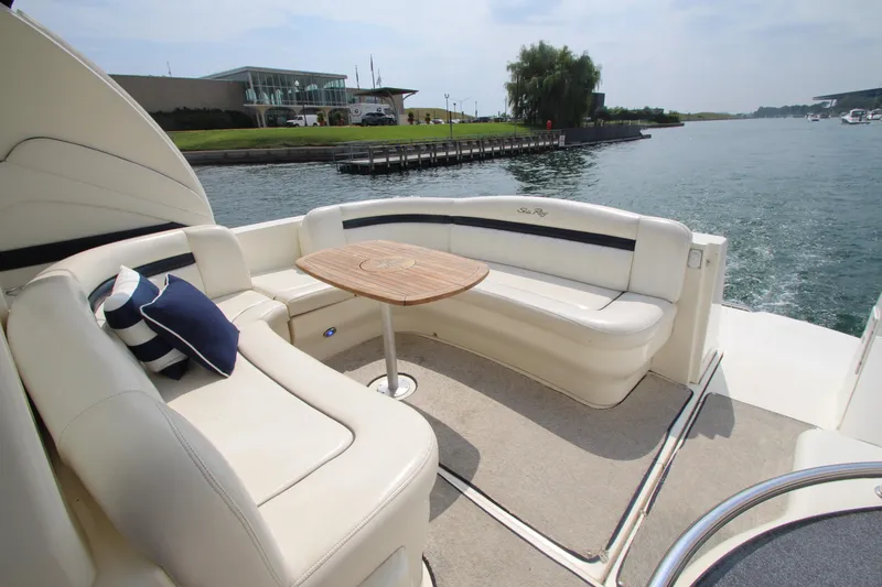 Slide: The Image of Luxurious 2004 Sea Ray 40 Sundancer yacht with elegant seating and scenic waterfront view. - 8