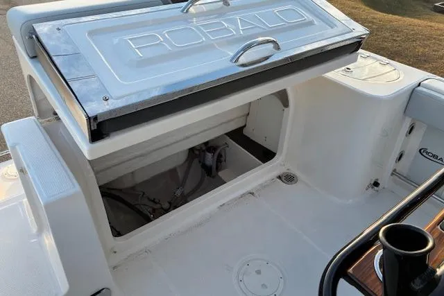 Slide: The Image of Robalo R230 Center Console 2026, open storage compartment on a boat. - 17