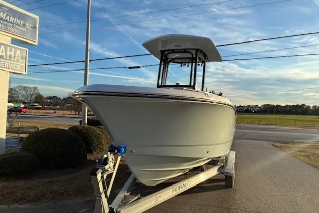 Slide: The Image of 2026 Robalo R230 Center Console on trailer at sunset. - 3