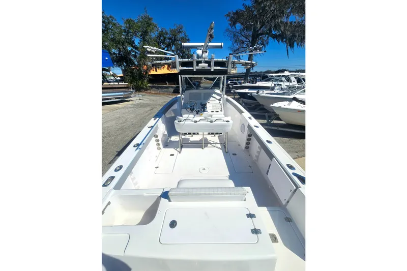 Slide: The Image of 2006 Donzi 32 ZF boat with spacious deck and modern features, docked under clear blue sky. - 11