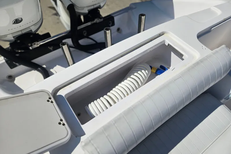 Slide: The Image of 2006 Donzi 32 ZF boat storage compartment with coiled hose and seating. - 13