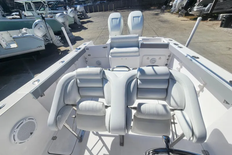 Slide: The Image of 2006 Donzi 32 ZF boat interior with white cushioned seating and dual outboard motors. - 17