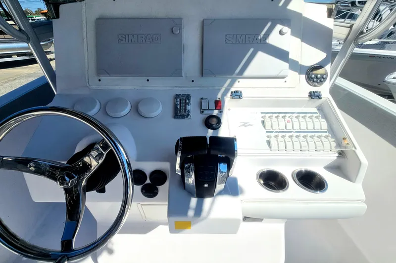 Slide: The Image of 2006 Donzi 32 ZF boat dashboard with steering wheel and control panel. - 19
