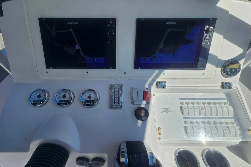Slide: The Image of Dashboard of a 2006 Donzi 32 ZF boat with Simrad displays and gauges. - 20
