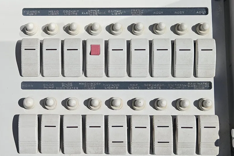 Slide: The Image of Control panel of a 2006 Donzi 32 ZF boat with labeled switches and knobs. - 22