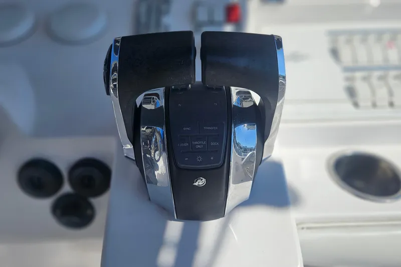 Slide: The Image of Throttle controls on a 2006 Donzi 32 ZF boat dashboard. - 23