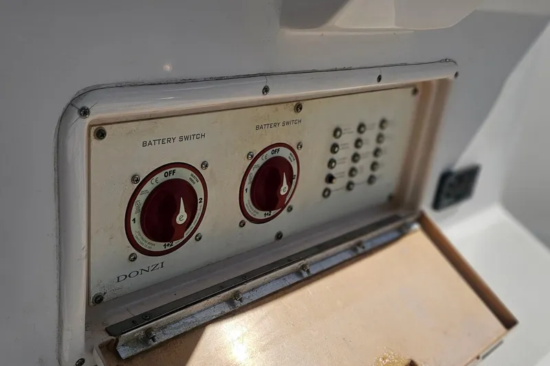 Slide: The Image of Battery switches on a 2006 Donzi 32 ZF boat control panel. - 24