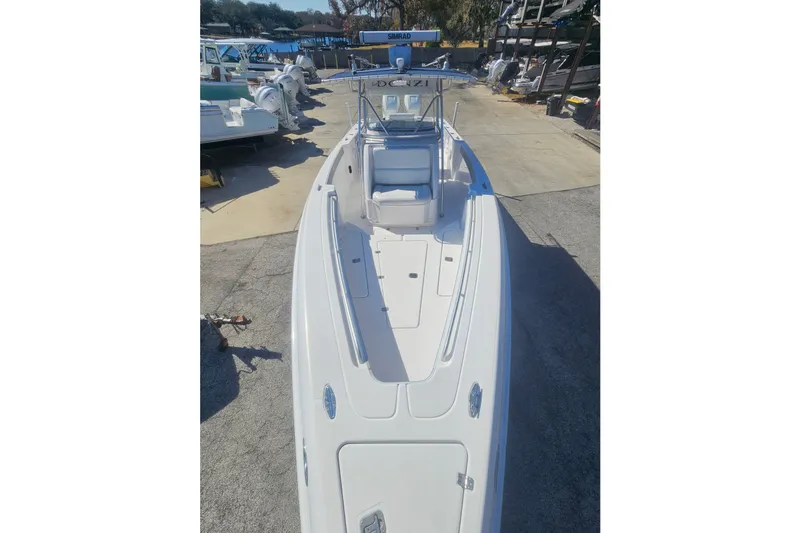 Slide: The Image of 2006 Donzi 32 ZF boat with sleek design, docked in a marina setting. - 26