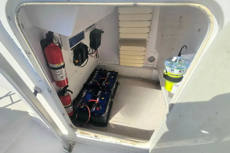 Slide: The Image of 2006 Donzi 32 ZF boat compartment with batteries, fire extinguisher, and safety equipment. - 27