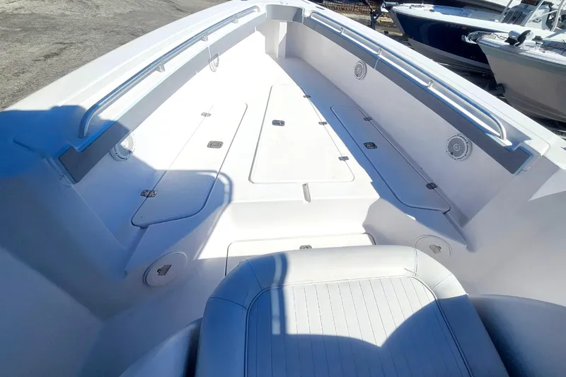 Slide: The Image of 2006 Donzi 32 ZF boat interior with white seating and storage compartments. - 29