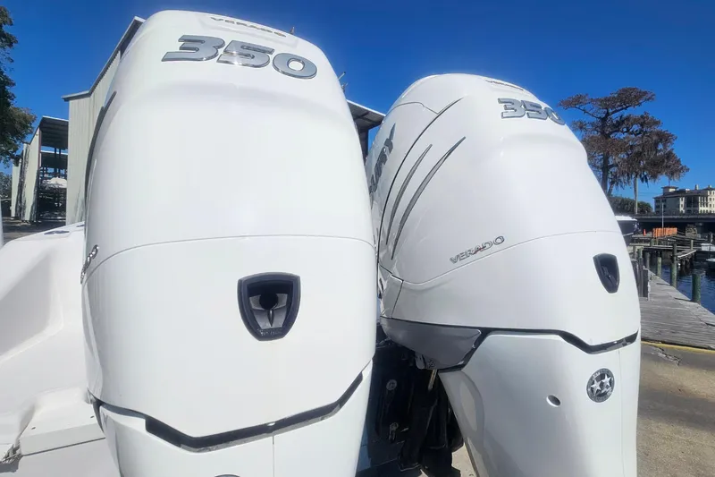 Slide: The Image of Twin Mercury Verado 350 engines on a 2006 Donzi 32 ZF boat at a marina. - 3