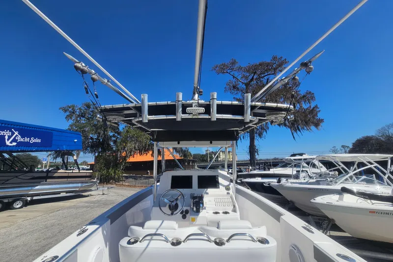 Slide: The Image of 2006 Donzi 32 ZF boat with center console and fishing equipment, docked at marina. - 32