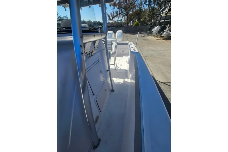 Slide: The Image of 2006 Donzi 32 ZF boat interior with console and seating, docked outdoors. - 34
