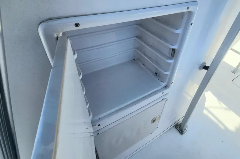 Slide: The Image of Open storage compartment on a 2006 Donzi 32 ZF boat, showcasing interior shelving. - 35