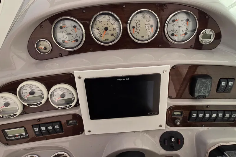 Slide: The Image of 2006 Chaparral Signature 310 dashboard with gauges and navigation system. - 13