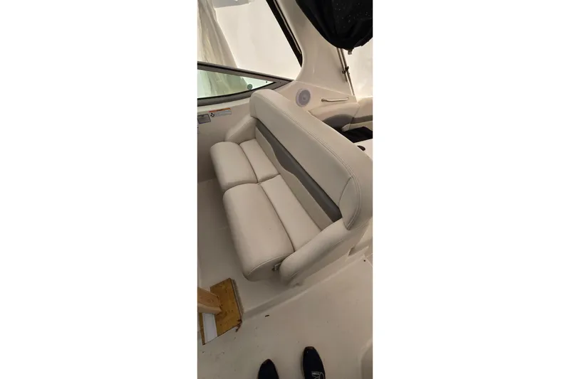 Slide: The Image of 2006 Chaparral Signature 310 boat interior with white seating and window view. - 15