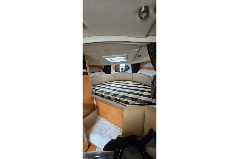 Slide: The Image of Interior cabin of 2006 Chaparral Signature 310 with checkered bedding. - 17