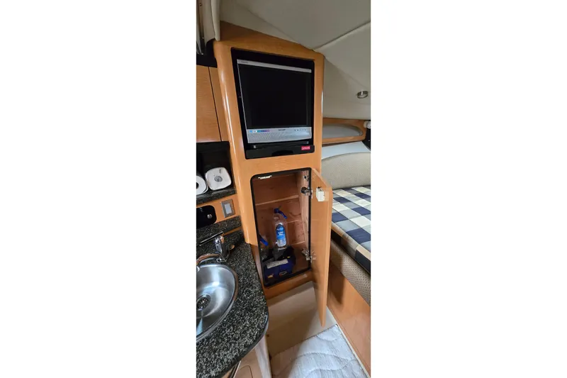 Slide: The Image of 2006 Chaparral Signature 310 interior with TV, sink, and storage cabinet. - 18