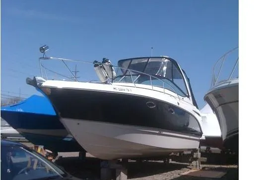 Slide: The Image of 2006 Chaparral Signature 310 boat on display in a marina setting. - 2