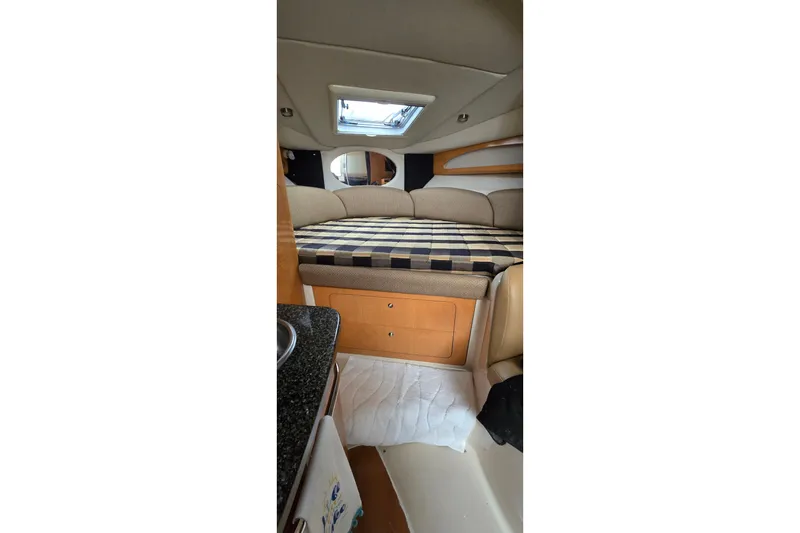 Slide: The Image of 2006 Chaparral Signature 310 cabin interior with bed and skylight. - 20