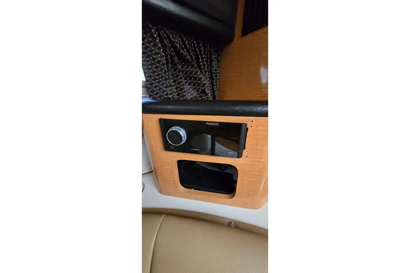 Slide: The Image of 2006 Chaparral Signature 310 interior with Fusion stereo system and wood paneling. - 23