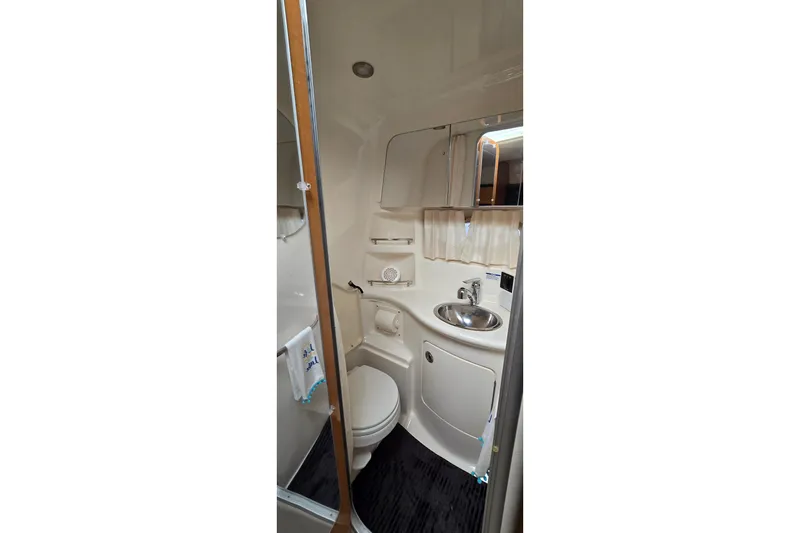 Slide: The Image of 2006 Chaparral Signature 310 bathroom with sink, toilet, and mirror. - 25