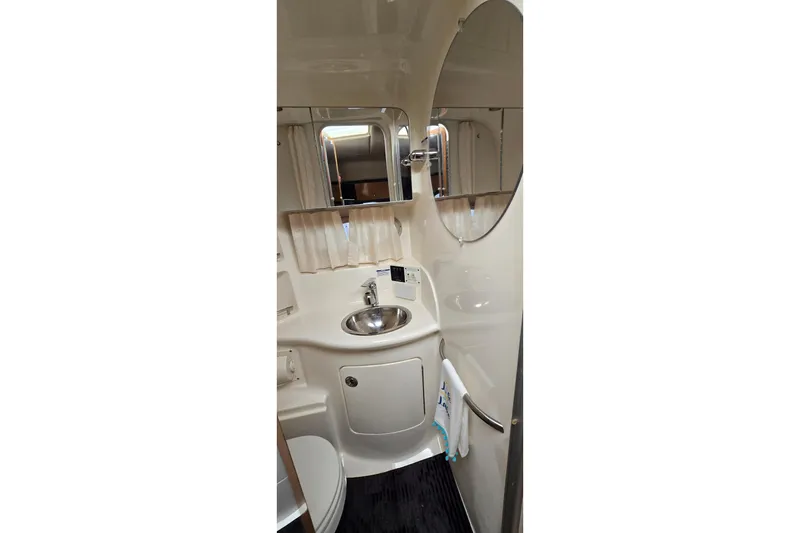 Slide: The Image of 2006 Chaparral Signature 310 boat bathroom with sink, mirror, and towel rack. - 27